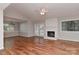 Open-concept living room with hardwood floors, fireplace, and ample natural light at 2706 Bremer Ct, Charlotte, NC 28210