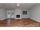 Bright living room with hardwood floors, fireplace, and view to kitchen area at 2706 Bremer Ct, Charlotte, NC 28210