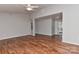 Open living room featuring hardwood floors, a ceiling fan, and neutral walls at 2706 Bremer Ct, Charlotte, NC 28210