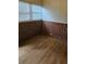 Basement featuring brick paneled walls, two windows, and vinyl flooring at 2828 Bellhaven Cir, Charlotte, NC 28214
