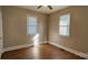 Bedroom with two windows, neutral walls, a ceiling fan, and wood look vinyl flooring at 2828 Bellhaven Cir, Charlotte, NC 28214