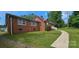 Side view of a brick home with a well-maintained lawn and inviting walkway at 2828 Bellhaven Cir, Charlotte, NC 28214