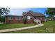 Charming brick home featuring a well-manicured lawn and inviting blue front door at 2828 Bellhaven Cir, Charlotte, NC 28214