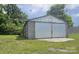 Spacious detached garage with large double doors and ample storage space at 2828 Bellhaven Cir, Charlotte, NC 28214