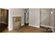 Spacious living room showcasing a classic stone fireplace and hardwood style floors at 2828 Bellhaven Cir, Charlotte, NC 28214