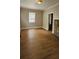 Cozy living room with vinyl floors, a stone fireplace, and classic trim at 2828 Bellhaven Cir, Charlotte, NC 28214