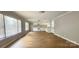 Bright, open living room featuring new vinyl flooring, large windows, and white trim at 2828 Bellhaven Cir, Charlotte, NC 28214