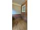 Cozy room with brick walls, hardwood floors, and natural light from the window at 2828 Bellhaven Cir, Charlotte, NC 28214