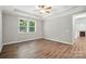 Bright bedroom features hardwood floors, a ceiling fan, and an adjacent fireplace view at 3029 Marchers Trace Dr, Charlotte, NC 28227