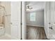 Bedroom features hardwood floors, neutral walls, ceiling fan, and adjacent bathroom at 3029 Marchers Trace Dr, Charlotte, NC 28227