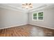 Bright bedroom with hardwood floors, ceiling fan, large window, and tray ceiling at 3029 Marchers Trace Dr, Charlotte, NC 28227
