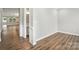 Hallway featuring hardwood floors with view to a half bath and a bright and open living space at 3029 Marchers Trace Dr, Charlotte, NC 28227