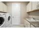 Well-organized laundry room featuring granite countertop, washer, dryer, and storage space at 3029 Marchers Trace Dr, Charlotte, NC 28227