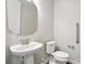 Half bathroom featuring pedestal sink, toilet, and grab bar for added convenience at 3029 Marchers Trace Dr, Charlotte, NC 28227