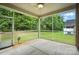 Relaxing screened porch offers tranquil views of the lush green backyard, ceiling fan, and concrete flooring at 3029 Marchers Trace Dr, Charlotte, NC 28227