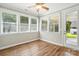 Sunroom with hardwood floors, ceiling fan, multiple windows, and access to a door at 3029 Marchers Trace Dr, Charlotte, NC 28227