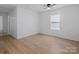 This large bedroom features a ceiling fan, window, and wood floors at 313 S Park Dr, Wadesboro, NC 28170