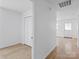 Bright hallway featuring modern wood floors and white walls at 313 S Park Dr, Wadesboro, NC 28170