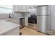 This kitchen features stainless steel appliances and white cabinets at 313 S Park Dr, Wadesboro, NC 28170
