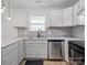 Bright kitchen features white cabinets, modern appliances, and speckled backsplash at 313 S Park Dr, Wadesboro, NC 28170