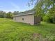 Side view of a one-story home surrounded by lush greenery at 313 S Park Dr, Wadesboro, NC 28170