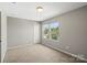 This bedroom features neutral carpeting and paint and natural light from two windows at 329 Brannon Meadows Dr, York, SC 29745