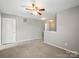 This bonus room features neutral carpet, ceiling fan, and plenty of natural light at 329 Brannon Meadows Dr, York, SC 29745