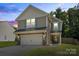 Charming two-story home featuring a two-car garage, landscaped yard, and neutral siding at 329 Brannon Meadows Dr, York, SC 29745