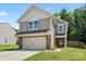 Charming two-story home featuring a two-car garage, landscaped yard, and neutral siding at 329 Brannon Meadows Dr, York, SC 29745