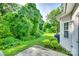 Backyard with lush green lawn, mature trees, and a concrete patio at 349 Valley Brook Se Ln, Concord, NC 28025