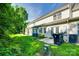 Backyard view with lawn, concrete patio, and mature trees at 349 Valley Brook Se Ln, Concord, NC 28025