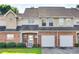 Charming townhome with brick facade, attached garages, manicured lawn, and inviting curb appeal at 349 Valley Brook Se Ln, Concord, NC 28025