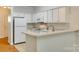 Bright, all-white kitchen with modern appliances and a peninsula counter at 349 Valley Brook Se Ln, Concord, NC 28025