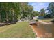 View of waterfront backyard with mature trees and shoreline access, creating a serene atmosphere at 364 Catalina Dr, Mooresville, NC 28117