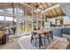Bright dining area with high ceilings, lake views, and stylish furnishings leading to a cozy kitchen at 364 Catalina Dr, Mooresville, NC 28117