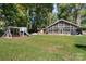 Exterior view of home with large screened porch, expansive yard, and lakeside views, ideal for outdoor living at 364 Catalina Dr, Mooresville, NC 28117
