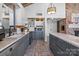 Charming kitchen features custom cabinets, stainless appliances, tile floors, and a unique brick accent wall at 364 Catalina Dr, Mooresville, NC 28117