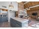 Open layout showcasing a kitchen island, brick fireplace, and seamlessly connected dining and living spaces at 364 Catalina Dr, Mooresville, NC 28117