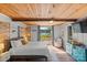 Sunlit main bedroom with a wooden ceiling and view to the lake from the sliding glass door at 364 Catalina Dr, Mooresville, NC 28117
