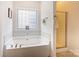 Large soaking tub and glass enclosed shower in bathroom at 3874 Willow Grove Ln, Concord, NC 28025
