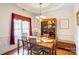 Elegant dining room with hardwood floors, decorative china cabinet, and bright natural light at 3874 Willow Grove Ln, Concord, NC 28025