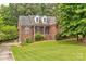Beautiful brick home showcasing manicured landscaping and charming architectural details at 3874 Willow Grove Ln, Concord, NC 28025