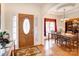 Inviting foyer with hardwood floors, wooden front door, and elegant dining area at 3874 Willow Grove Ln, Concord, NC 28025