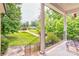View from front porch showcasing mature trees and landscaping at 3874 Willow Grove Ln, Concord, NC 28025