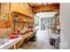 Open garage area with workbench, utility sink, and signage and posters on the wall at 3874 Willow Grove Ln, Concord, NC 28025