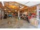 Spacious garage with exposed ceiling, concrete floor, and walls with various tools and accessories at 3874 Willow Grove Ln, Concord, NC 28025