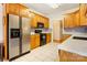 Well-lit kitchen with stainless steel appliances, light countertops, and wood cabinets at 3874 Willow Grove Ln, Concord, NC 28025