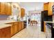 Bright kitchen with an eat-in area, wood cabinets, light countertops, and modern appliances at 3874 Willow Grove Ln, Concord, NC 28025