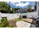 Cozy backyard features a fire pit, artificial turf, patio area, grill, and white privacy fence at 432 W Worthington Ave, Charlotte, NC 28203