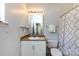 Cozy bathroom features a vanity, mirror, toilet, and bathtub with shower curtain for essential comfort and functionality at 432 W Worthington Ave, Charlotte, NC 28203